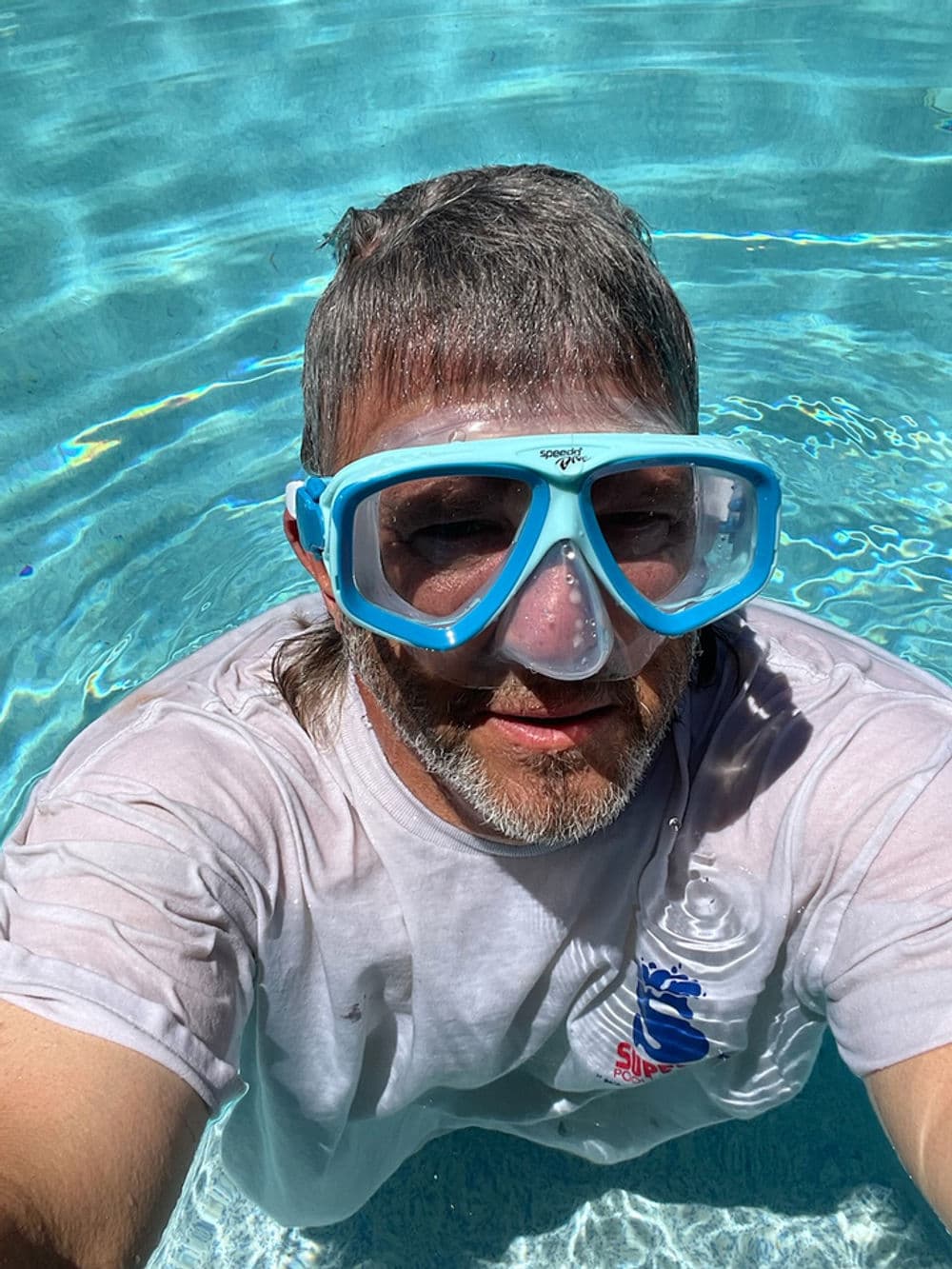 Our technician servicing a pool ensuring optimal water chemistry.